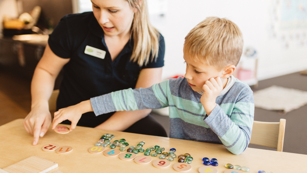 Educator and boy counting marbles, newsletter image