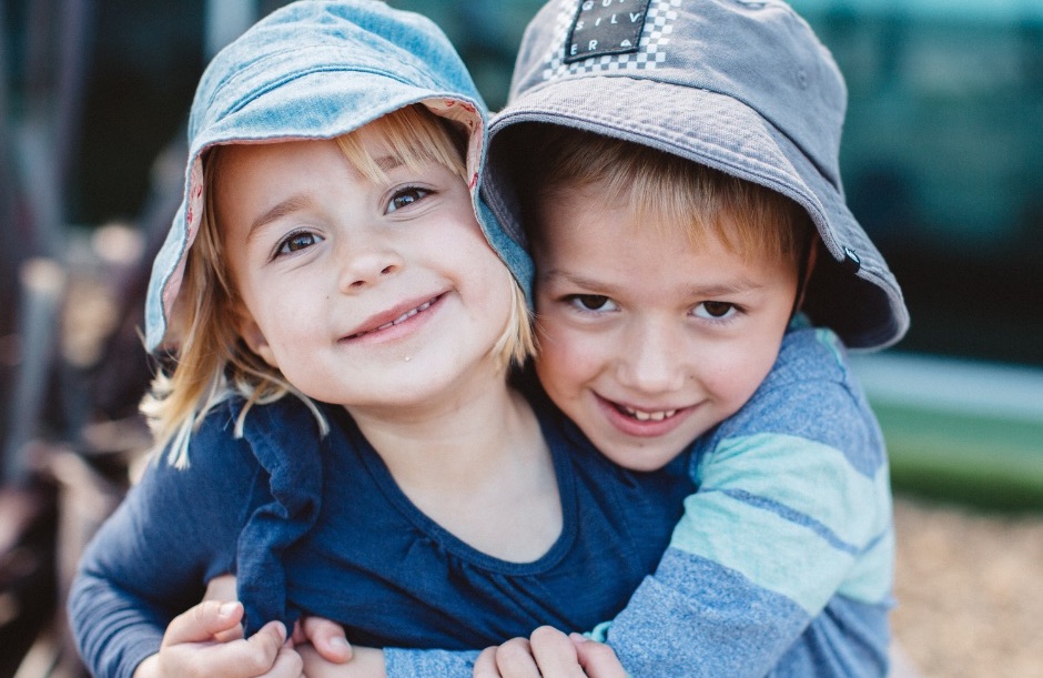 Children hugging at Explore & Develop 